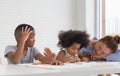 Cute little child girl and boy drawing at home, children with grandmother playing in living room Royalty Free Stock Photo