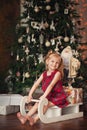 Cute little child girl in dress smiling and having fun on bed in white bedroom Royalty Free Stock Photo