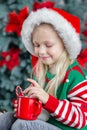 Cute little child girl eating sweet cookies and drinking hot chocolate Royalty Free Stock Photo