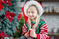 Cute little child girl eating sweet cookies and drinking hot chocolate Royalty Free Stock Photo