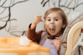 Cute little child girl eating yogurt indoors Royalty Free Stock Photo