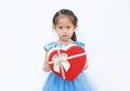 Cute little child girl holding red heart gift box for Valentine`s Day isolated on white background Royalty Free Stock Photo