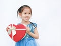 Cute little child girl holding red heart gift box for Valentine`s Day isolated on white background Royalty Free Stock Photo