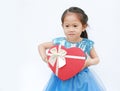 Cute little child girl holding red heart gift box for Valentine`s Day isolated on white background Royalty Free Stock Photo