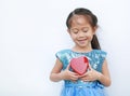 Cute little child girl holding red heart gift box for Valentine`s Day isolated on white background Royalty Free Stock Photo