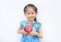 Cute little child girl holding red heart gift box for Valentine`s Day isolated on white background Royalty Free Stock Photo