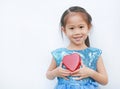 Cute little child girl holding red heart gift box for Valentine`s Day isolated on white background Royalty Free Stock Photo