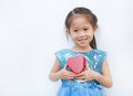 Cute little child girl holding red heart gift box for Valentine`s Day isolated on white background Royalty Free Stock Photo