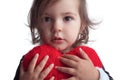 Cute little child girl portrait holding red heart toy on white b Royalty Free Stock Photo