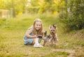 Child girl with her little Yorkshire terrier dog in the park Royalty Free Stock Photo
