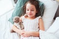 cute little child girl sleeping and watching sweet dreams with her teddy bear Royalty Free Stock Photo