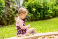 Cute little child girl in a swimsuit playing with stones on a pebble beach Royalty Free Stock Photo