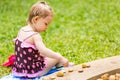 Cute little child girl in a swimsuit playing with stones on a pebble beach Royalty Free Stock Photo