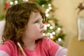 Cute little child girl writes the letter to Santa Claus near Christmas tree indoors. Royalty Free Stock Photo