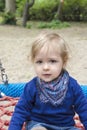 Cute little child having fun on a colorful swing outdoor in the park. Beautiful spring day in children playground Royalty Free Stock Photo