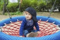 Cute little child having fun on a colorful swing outdoor in the park. Beautiful spring day in children playground Royalty Free Stock Photo