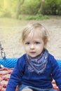 Cute little child having fun on a colorful swing outdoor in the park. Beautiful spring day in children playground Royalty Free Stock Photo