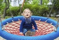 Cute little child having fun on a colorful swing outdoor in the park. Beautiful spring day in children playground Royalty Free Stock Photo