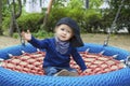 Cute little child having fun on a colorful swing outdoor in the park. Beautiful spring day in children playground Royalty Free Stock Photo