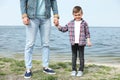 Cute little child holding hands with his father. Family time Royalty Free Stock Photo