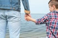 Cute little child holding hands with his father near river Royalty Free Stock Photo