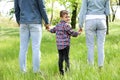 Cute little child holding hands with his parents. Family time Royalty Free Stock Photo