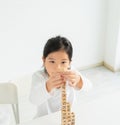cute little child intend to play alphabet block on table. asian children study and learn alphabet, scrabble, crossword in Royalty Free Stock Photo