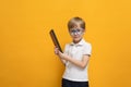 Cute little school boy in glasses holding abacus on yellow background. Mental arithmetic, math, mathematics Royalty Free Stock Photo