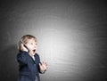 Cute little child on the phone near a chalkboard