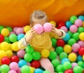 Cute little child playing in ball pit at amusement park Royalty Free Stock Photo