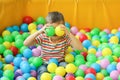 Cute little child playing in ball pit at indoor park Royalty Free Stock Photo