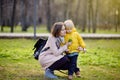 Cute little boy with his young mother playing in park Royalty Free Stock Photo