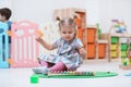 Little child playing with xylophone on floor Royalty Free Stock Photo