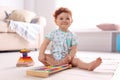 Cute little child playing with xylophone on floor Royalty Free Stock Photo