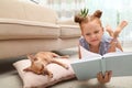Cute little child reading book while her Chihuahua dog sleeping at home. Adorable pet Royalty Free Stock Photo
