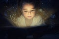 Cute child reading magic book in darkness Royalty Free Stock Photo