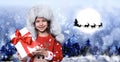 Cute little child and Santa Claus flying in his sleigh against moon sky on background. Christmas celebration Royalty Free Stock Photo