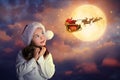 Cute little child and Santa Claus flying in his sleigh on background. Christmas celebration Royalty Free Stock Photo