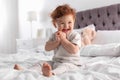 Cute little child sitting on bed Royalty Free Stock Photo