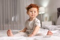 Cute little child sitting on bed Royalty Free Stock Photo