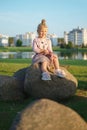 Little child sitting on stone in sunset Royalty Free Stock Photo