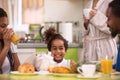 Cute little child at the table with family in the kitchen Royalty Free Stock Photo