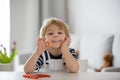 Cute little child, toddler boy, eating alfa omega 3 child supplement vitamin pills at home Royalty Free Stock Photo