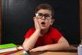 Cute little child wearing glasses at desk. First time at school Royalty Free Stock Photo