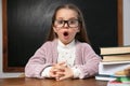 Cute little child wearing glasses at desk in classroom Royalty Free Stock Photo