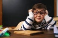 Cute little child wearing glasses at desk. First time at school Royalty Free Stock Photo