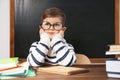 Cute little child wearing glasses at desk. First time at school Royalty Free Stock Photo