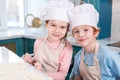 cute little children in chef hats and flour on faces smiling Royalty Free Stock Photo