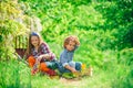 Cute little children enjoying on farm. Children farmer concept. Children play in spring garden. Happy kids work plant