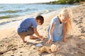 Cute little children gathering sea shells on beach Royalty Free Stock Photo